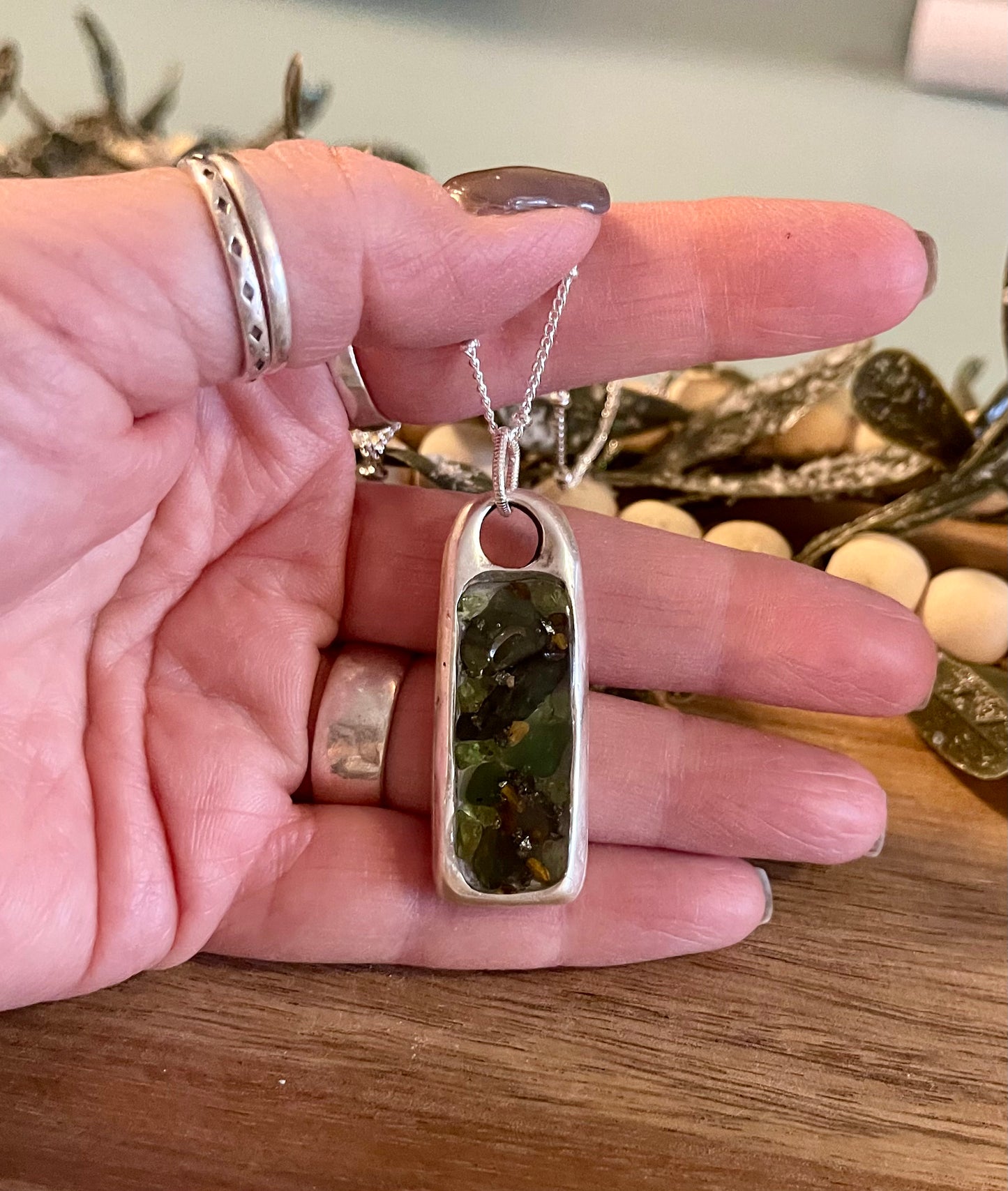 Peridot, emerald and pyrite pendant with a mustard seed